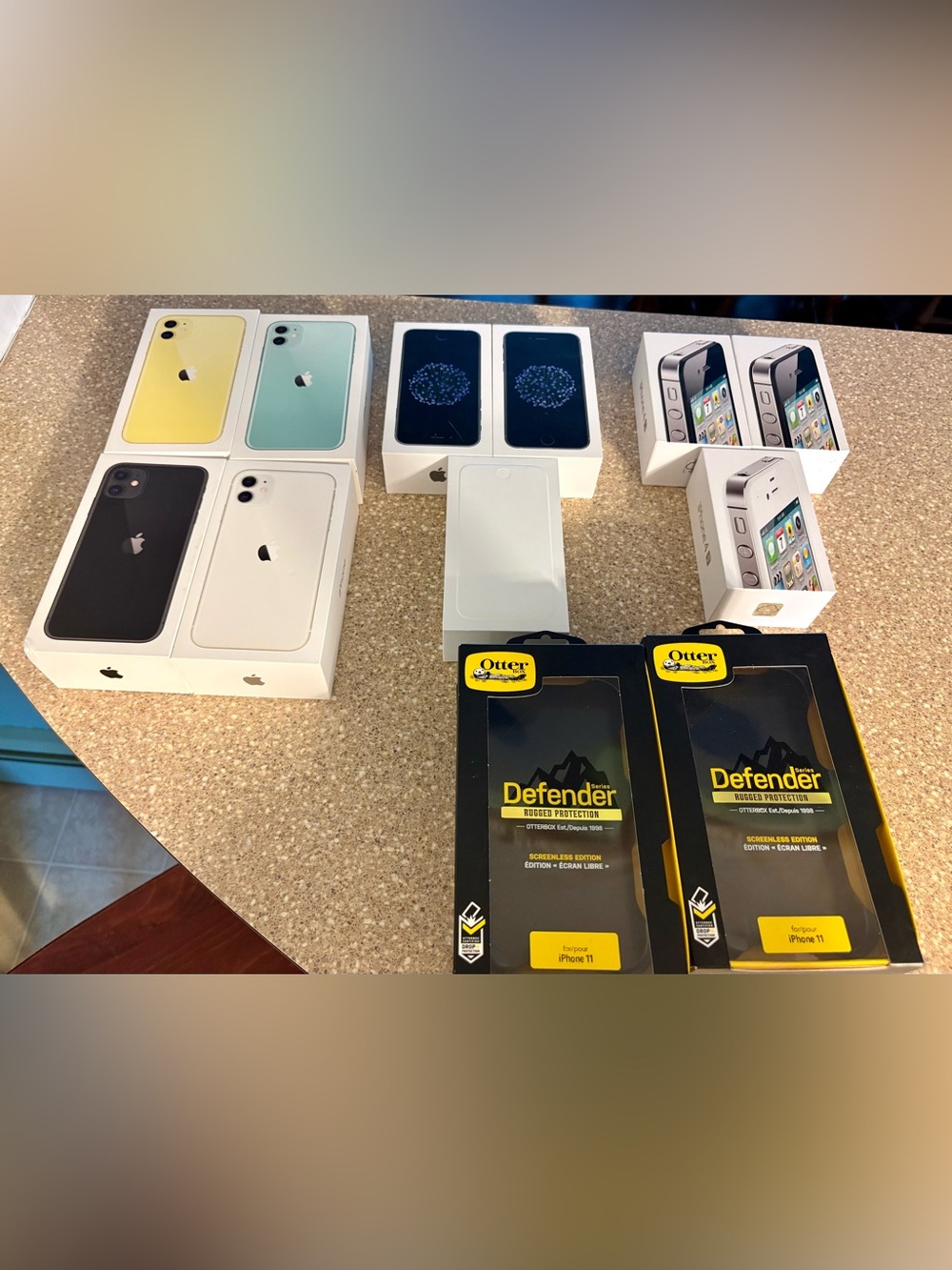 Empty Apple iPhone Boxes Assorted Colors with OtterBox Defender Cases